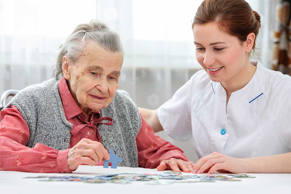 Caring staff member interacting with memory care resident